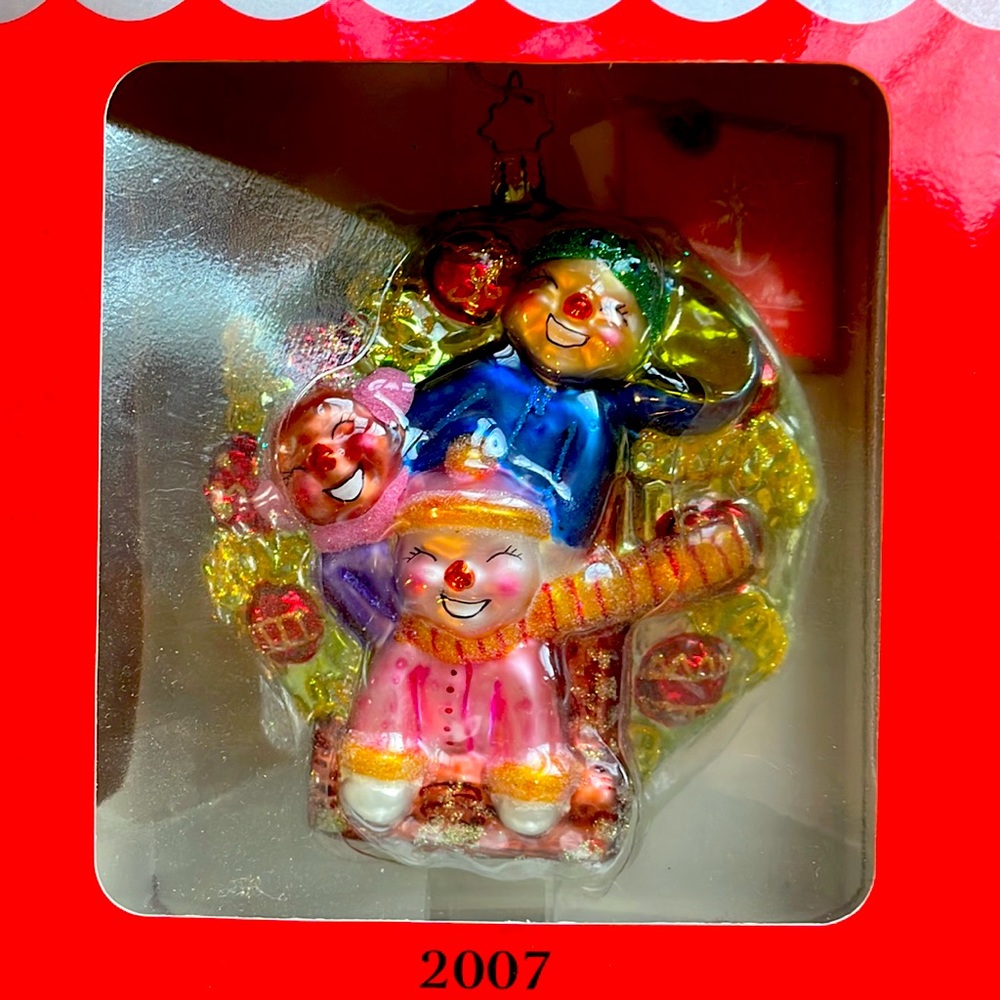 Christopher Radko ornament with three children/ snowmen.